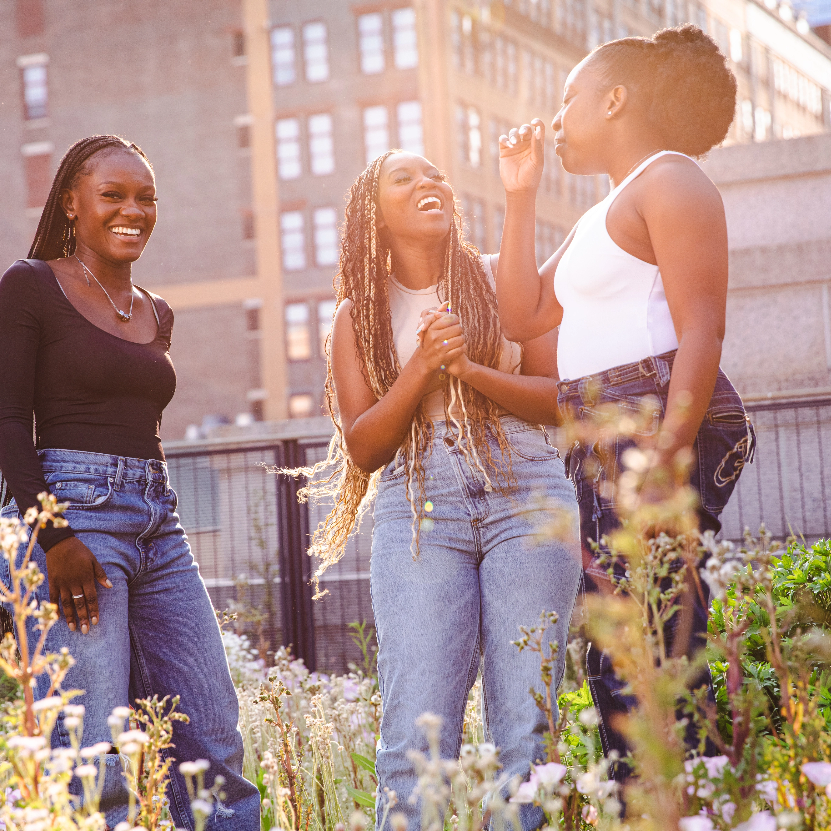 Three women laughing and talking to each other.